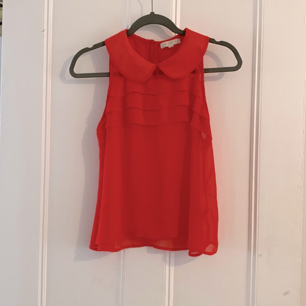 Coral colored chiffon shirt.